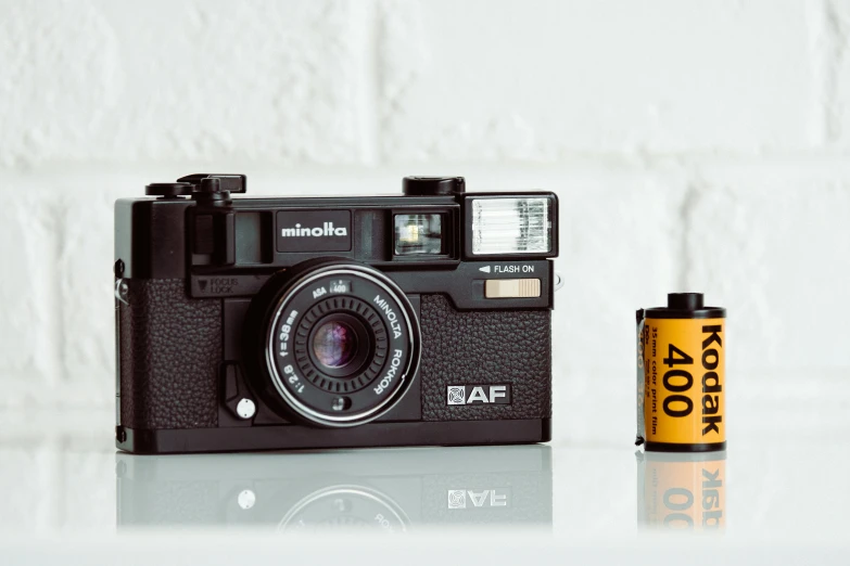 an old camera and batteries are on the table