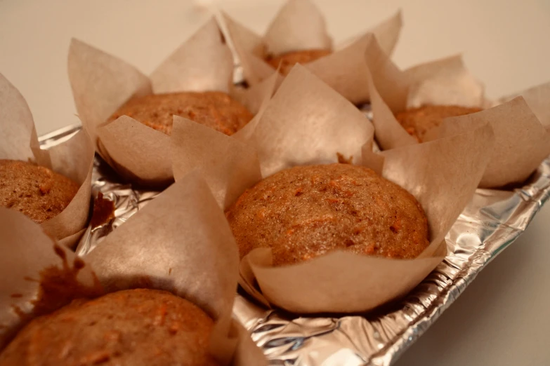 several small cupcakes in foil lined up