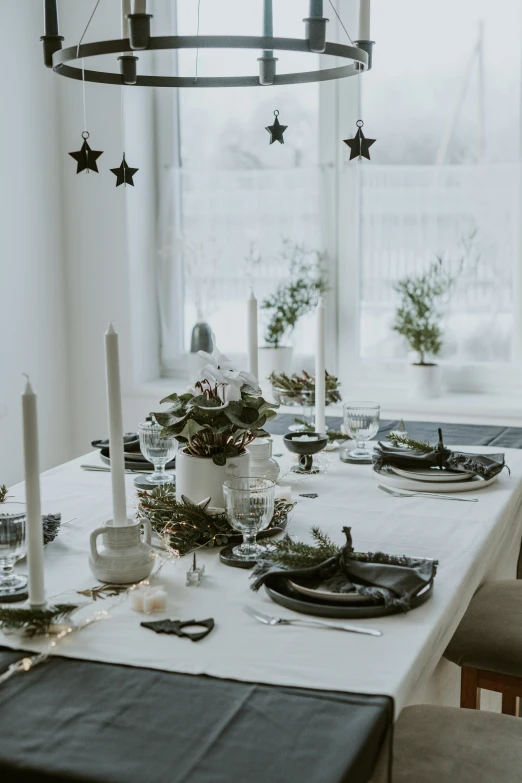 a table is set for christmas with white stars