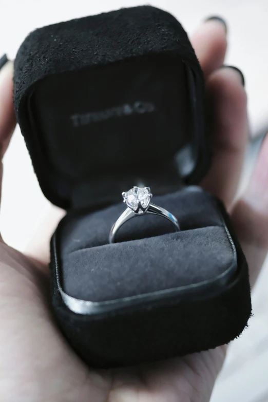 an oval brilliant diamond engagement ring in a velvet box