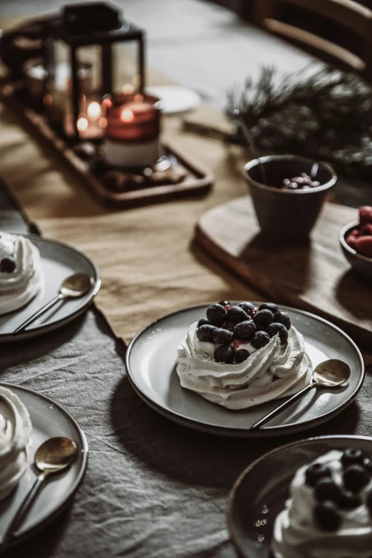 a table topped with three plates of dessert