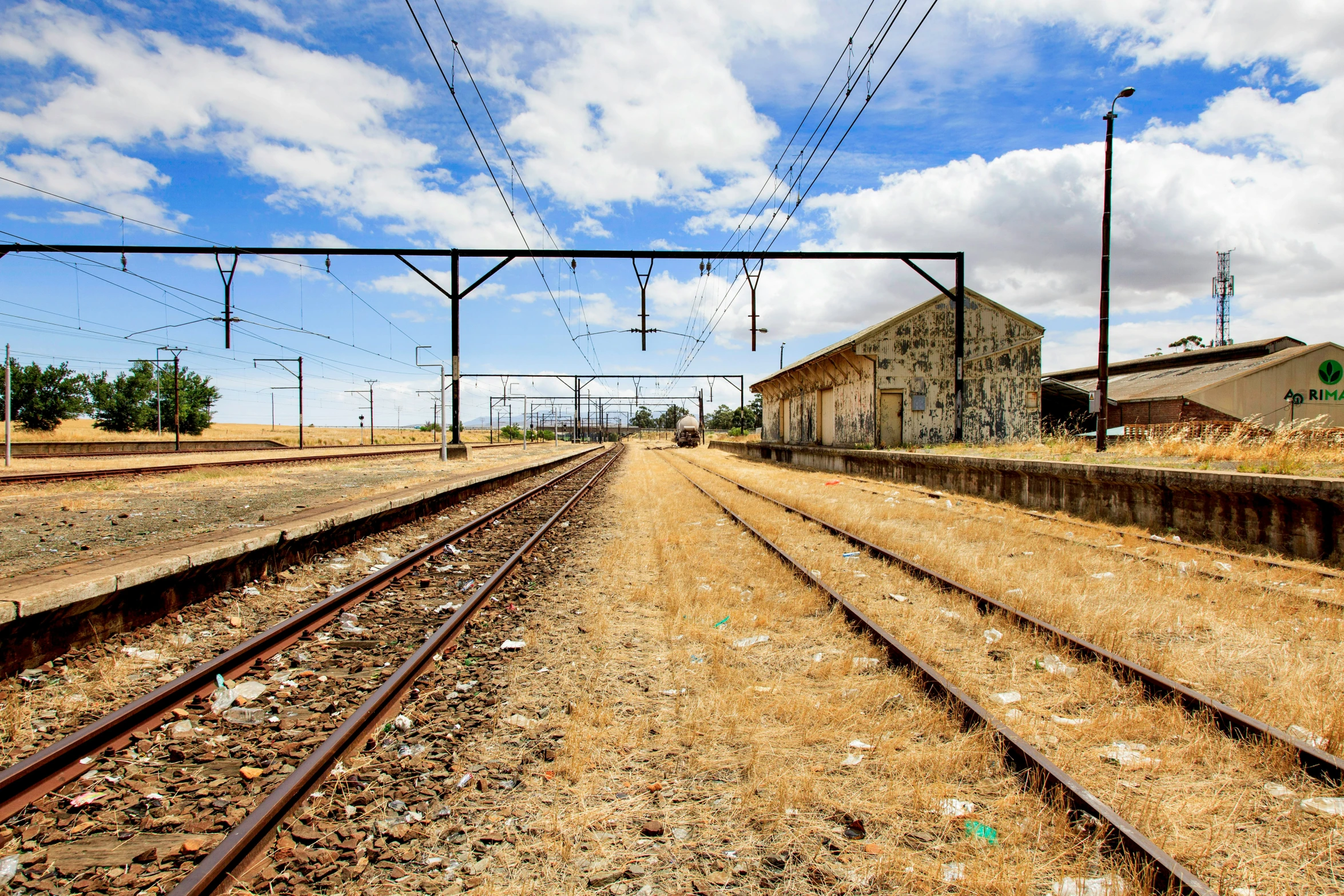 a train track next to a building on top of it