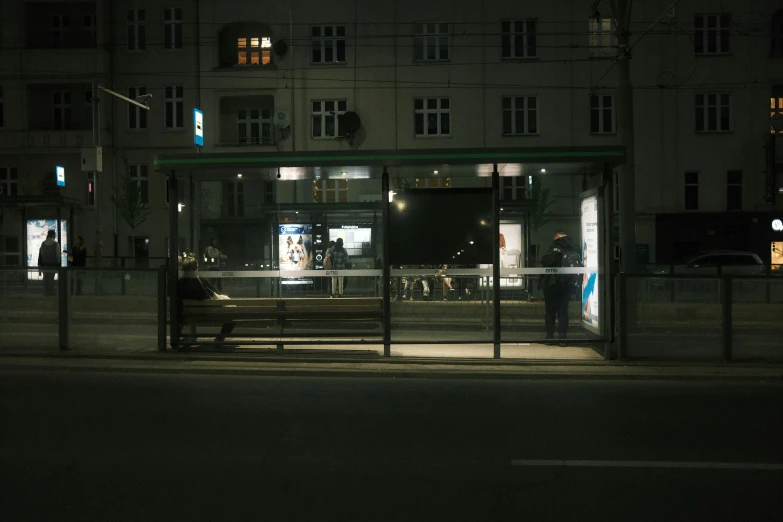 a night time picture of a bus stop