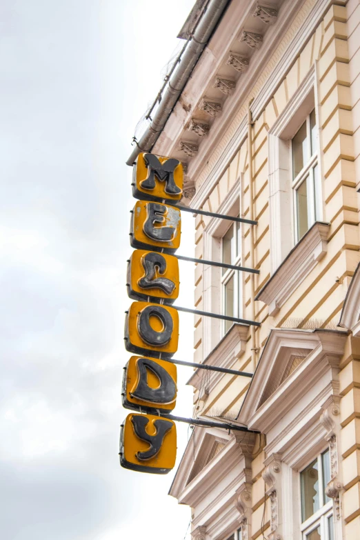 a large sign hanging off the side of a building