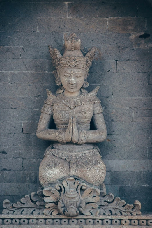 a small statue sitting on top of a stone floor