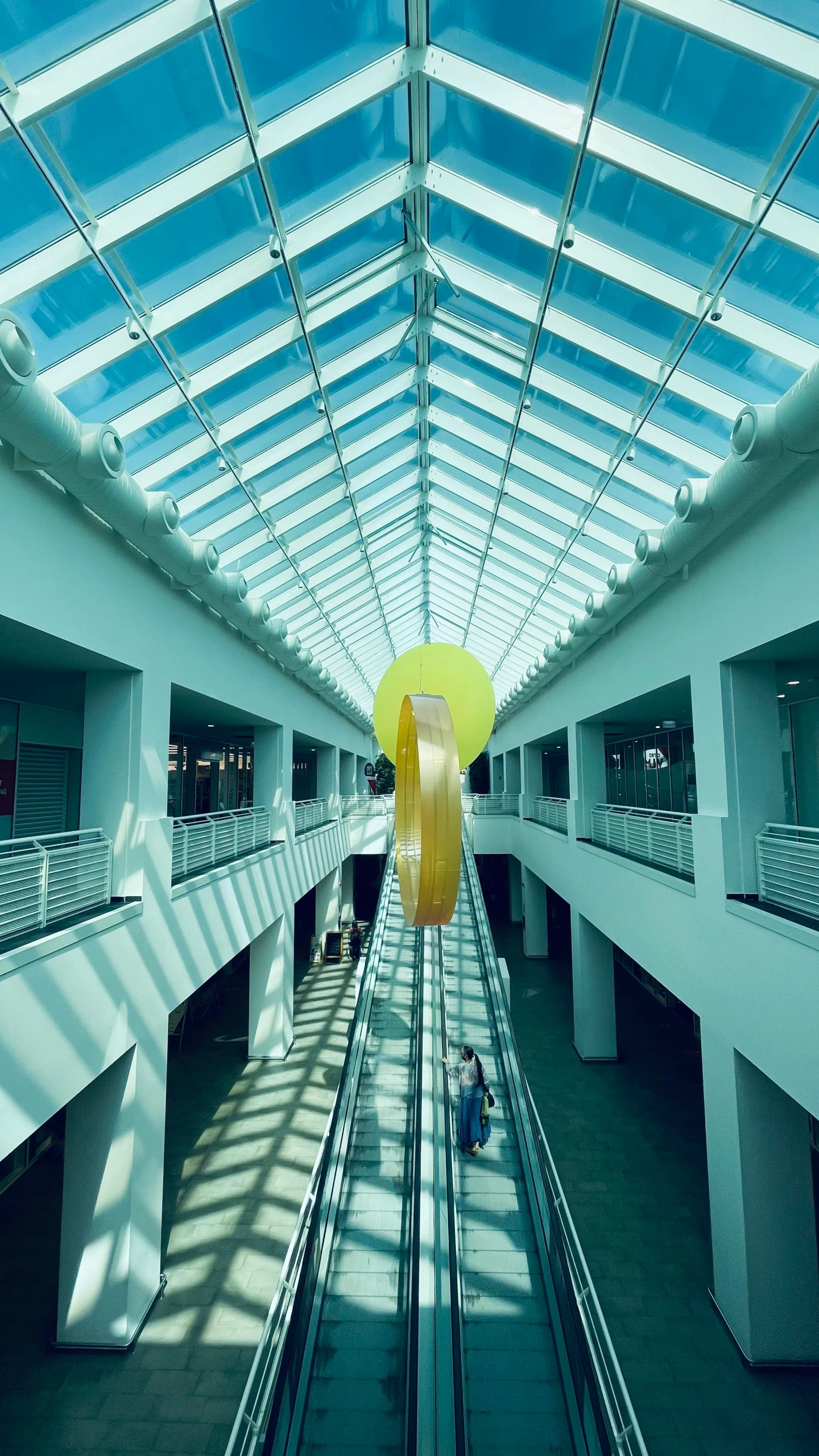 an empty building with bright glass ceiling above