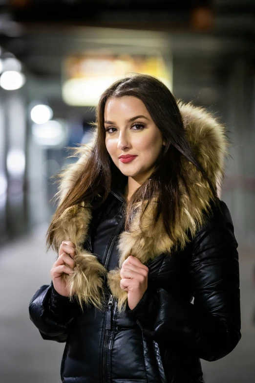 a woman wearing a fur - lined coat and black jacket