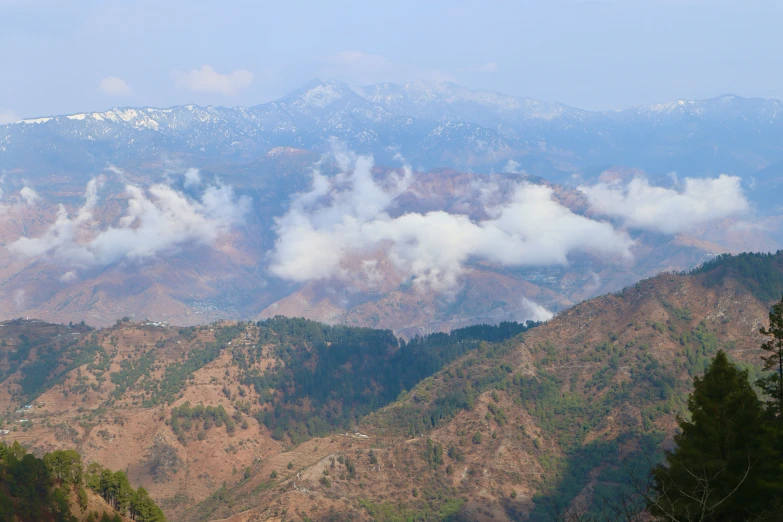 a mountainous landscape with low lying clouds over the mountains