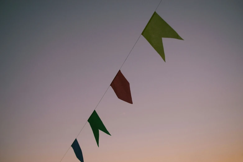 a few flags with a sky in the background