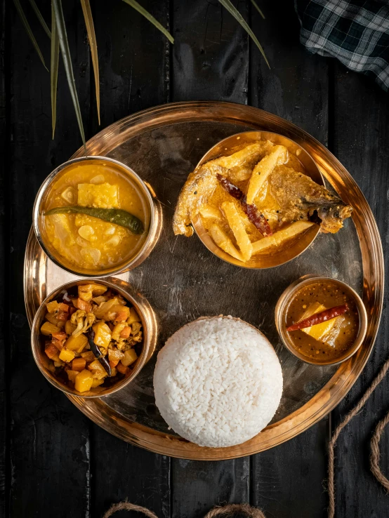 a plate with soups, rice, and fried fish on it