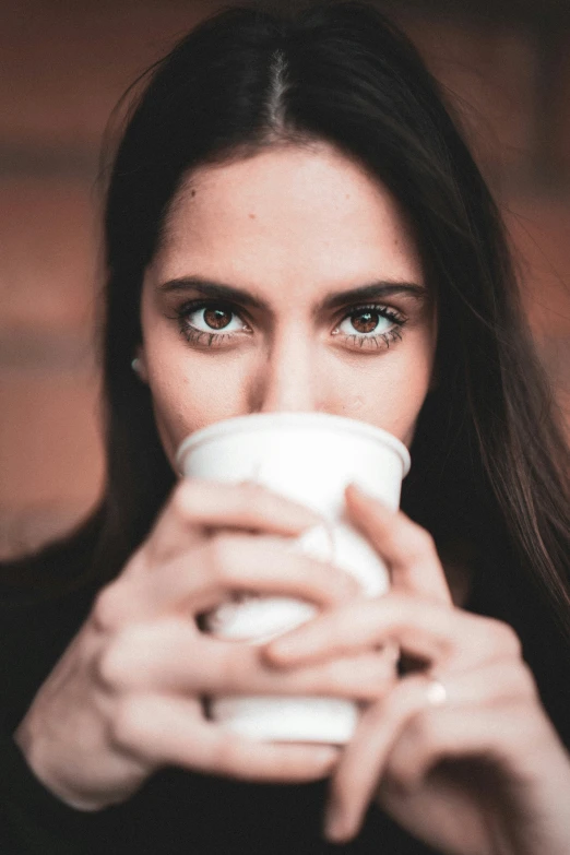 a woman holding a coffee mug in her hands