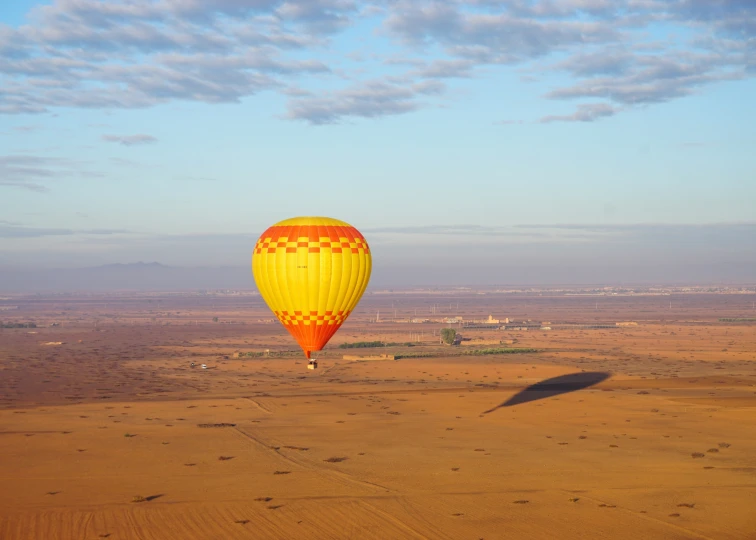 a  air balloon in the desert against a blue sky