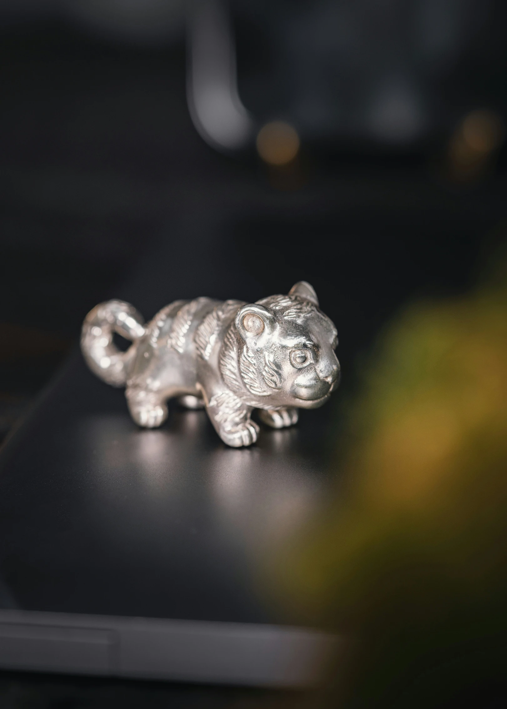 small silver colored tiger figurine on a table