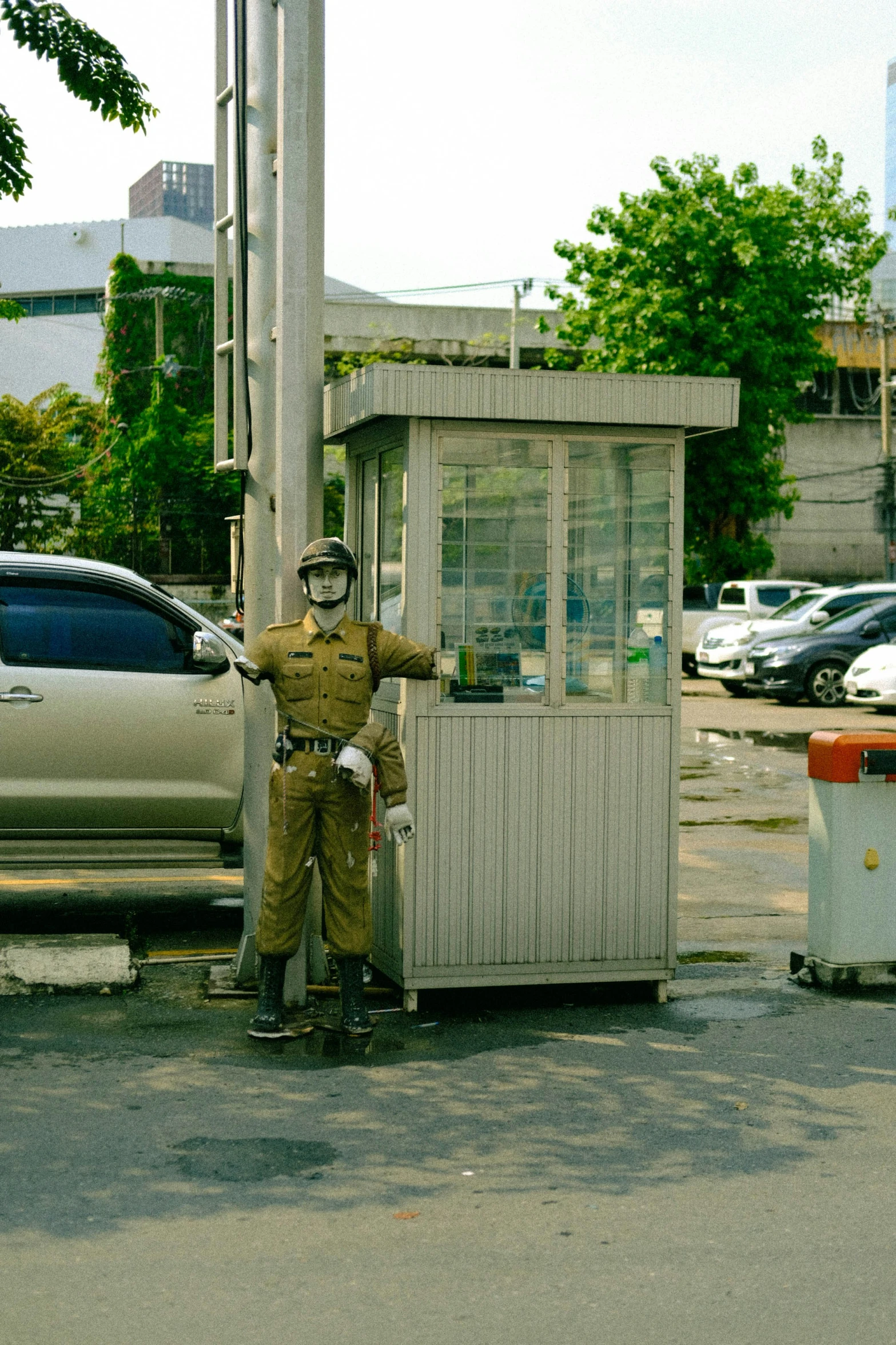 man standing in front of a small booth in the middle of a street