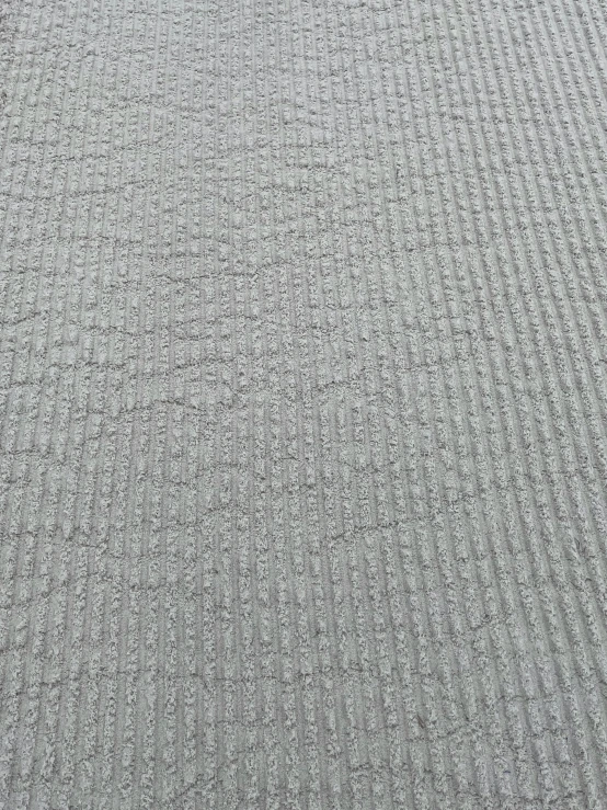 the grey, gy textured surface of a soft wool rug