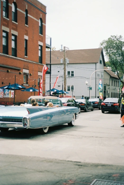 a car driving down the road in front of a couple