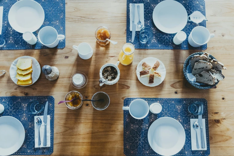 the table set up with many plates and glasses for two