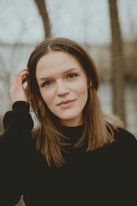 a woman is smiling while posing for a po