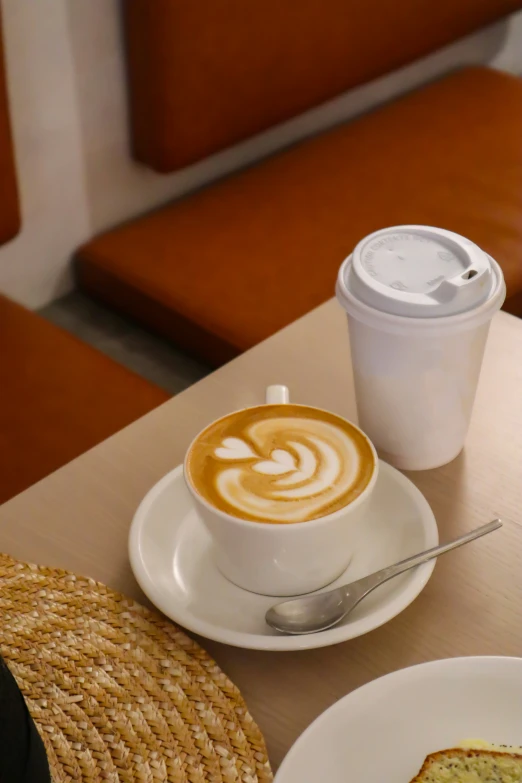 a cappuccino is served in a white mug