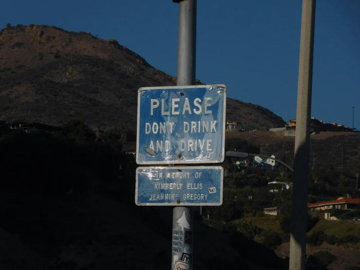 there are two signs on a pole on the street