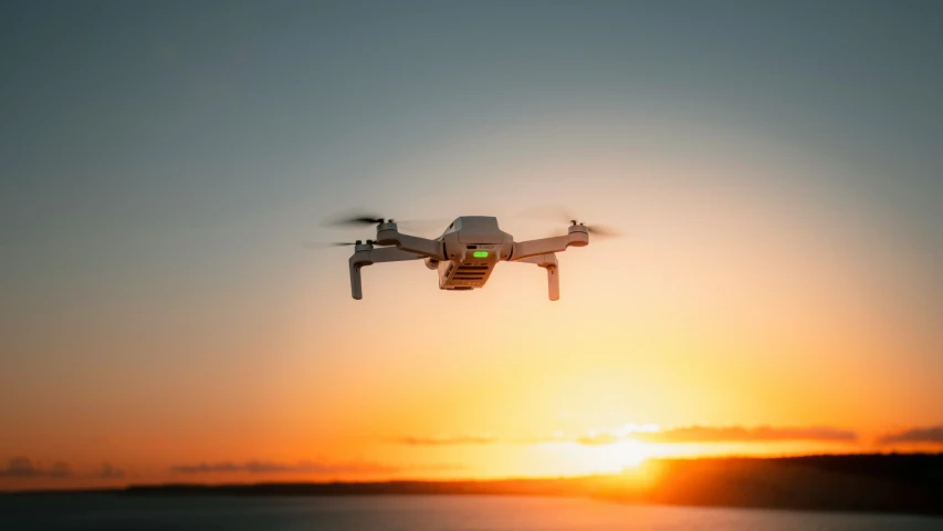 a large white dji - cxr flying over a lake