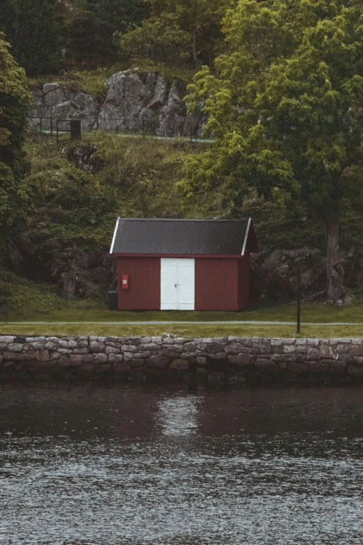 an older style building sitting on the side of a body of water