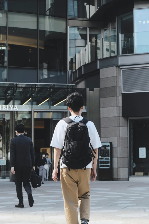 a man walking around outside an office building