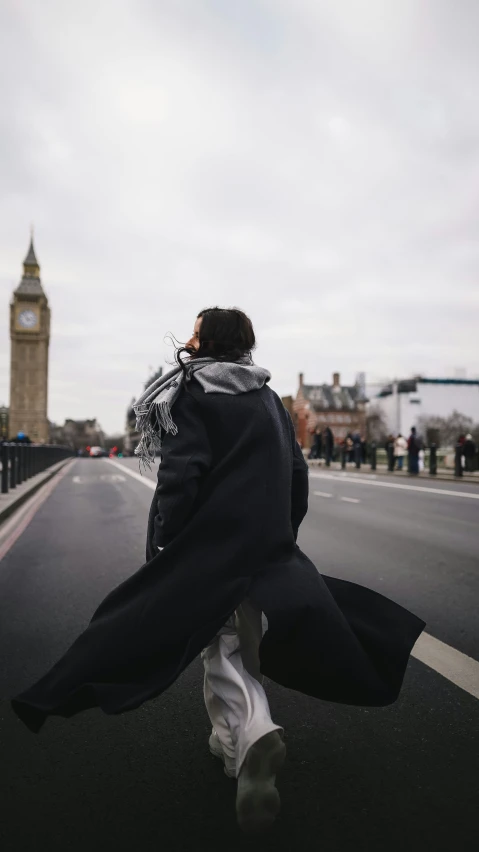 the woman is walking alone along the street