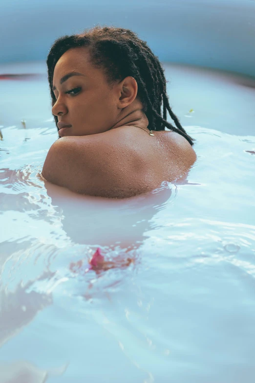 a woman swims in the water with a smile