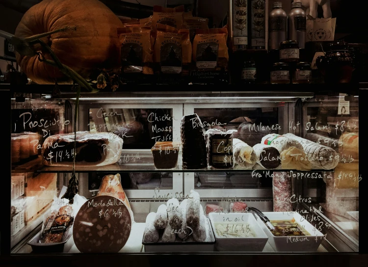 a bakery display window with assorted pastries inside