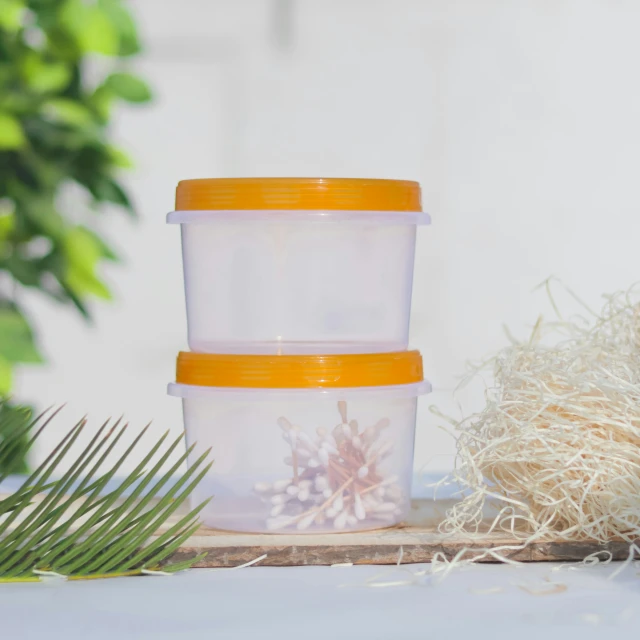 a couple of containers sitting on top of a wooden table