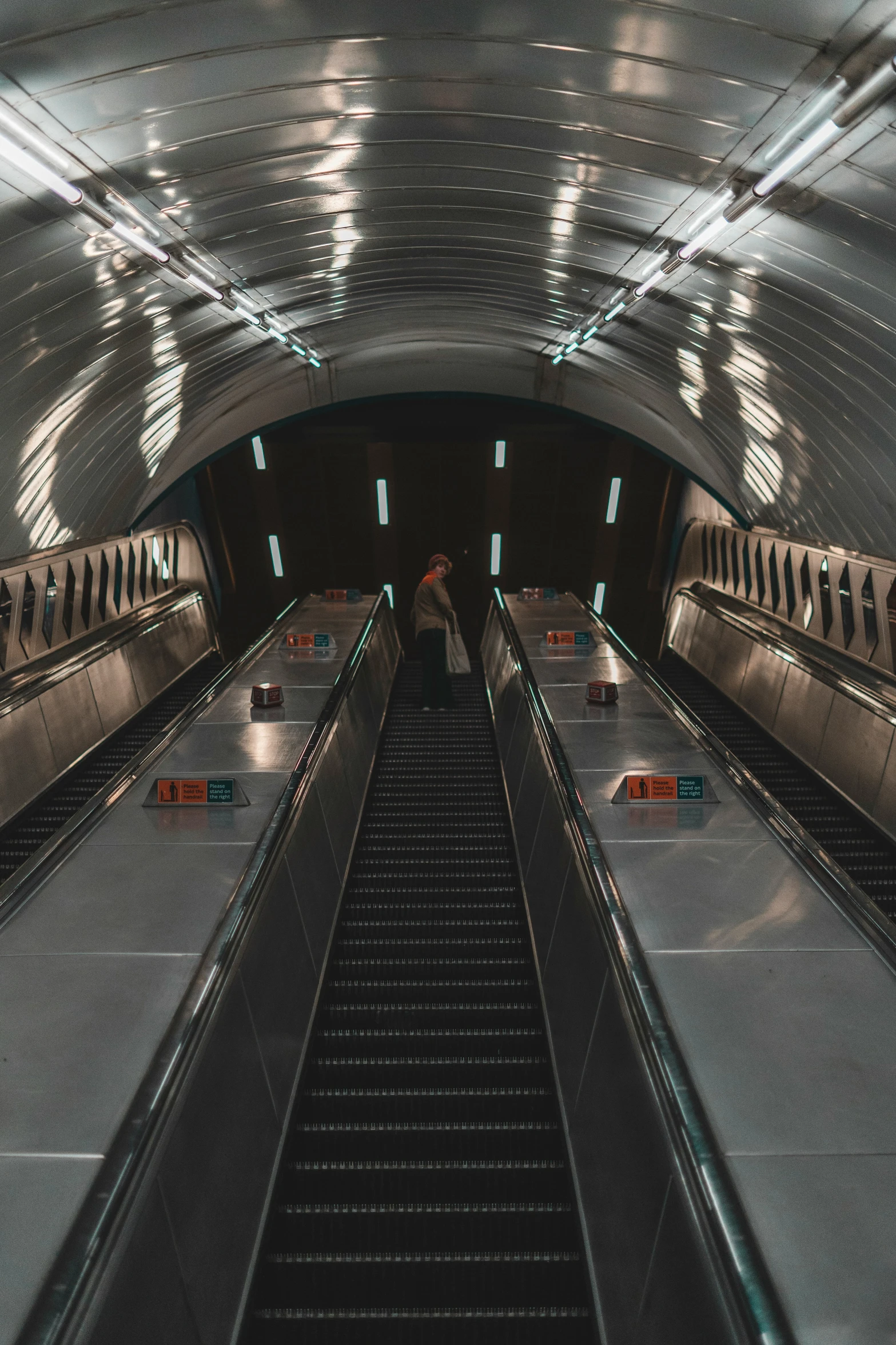 people riding on escalators in a subway or subway station