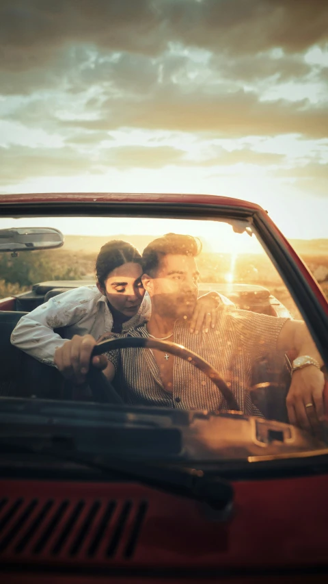 two men sitting in the driver's seat of a vehicle