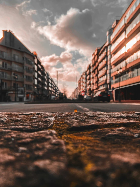 a red brick building on an intersection near a parking lot