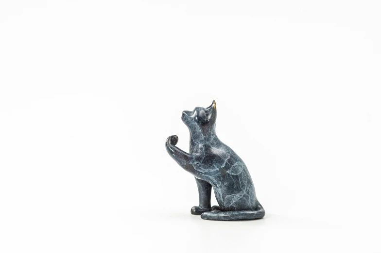 black statue with the hands of a cat stretched out