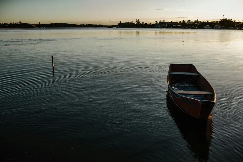 a boat is anchored on the water near trees