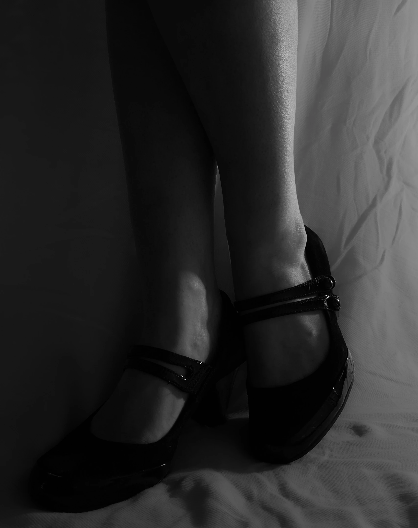 a person in heels that are standing on the bed