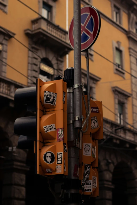 a street sign with different stickers on it