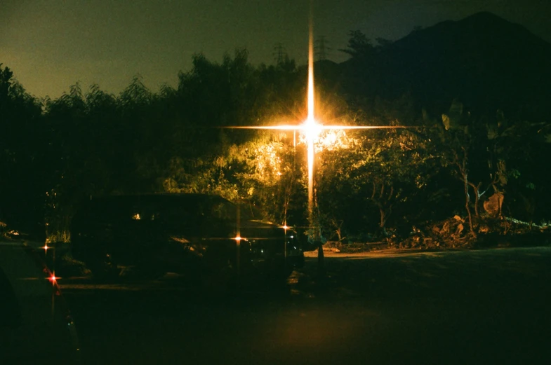 some cars parked on the side of a street at night