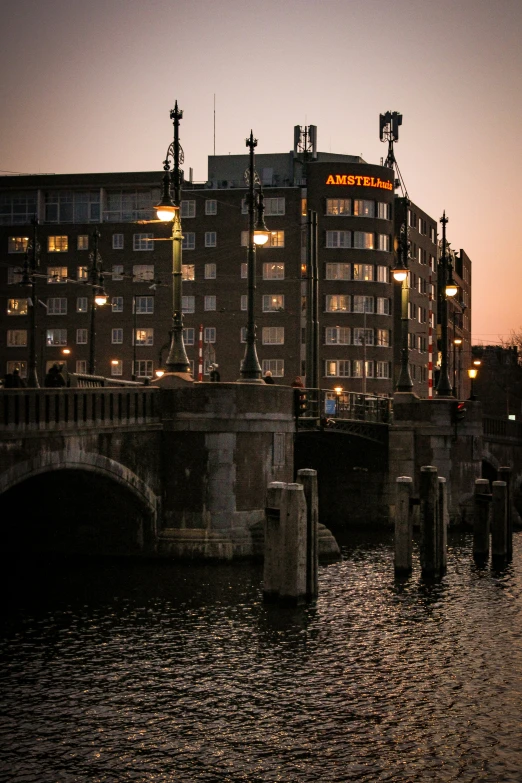 a bridge in the evening with a building behind it