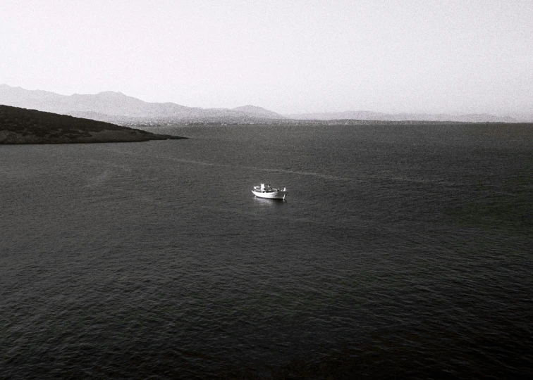 a boat in the ocean sailing across water