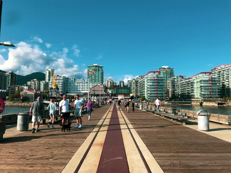 a large group of people on a bridge by the water