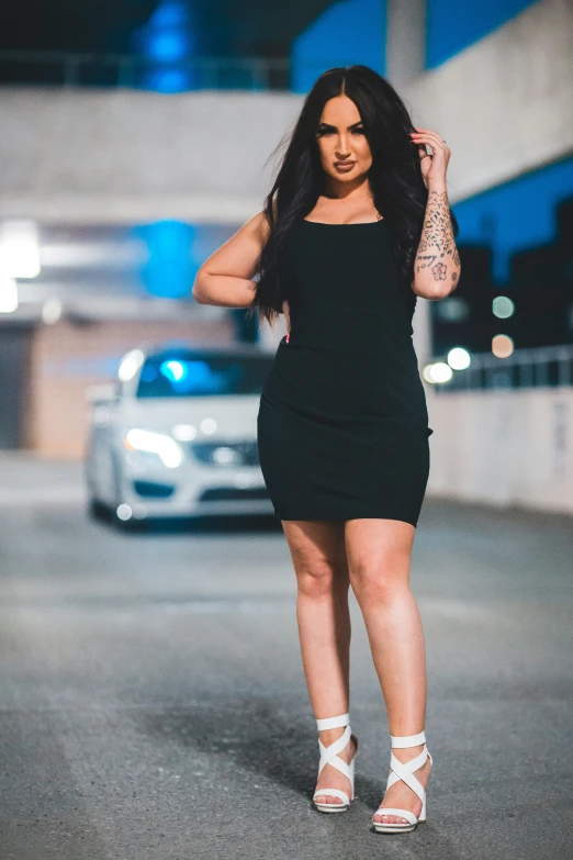 a woman in a short black dress and heels