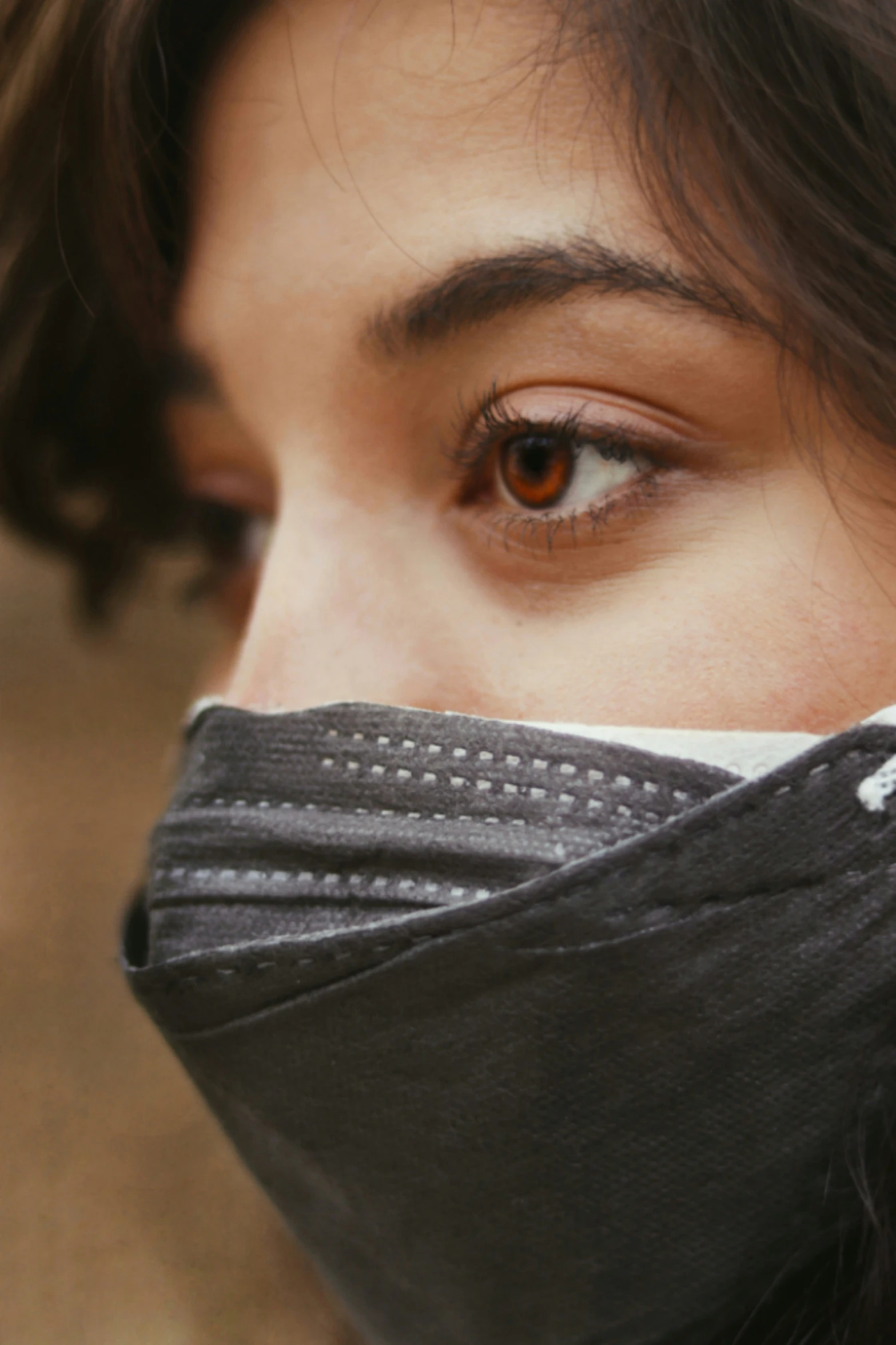 a close up of a woman wearing a mask