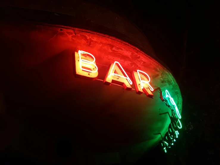 a neon sign is displayed on a building