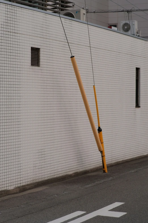 a crane on the side of a building and bent over