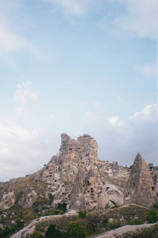 a rocky landscape is pictured under a blue sky