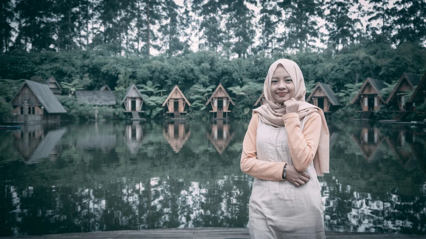 there is a woman standing in front of a body of water