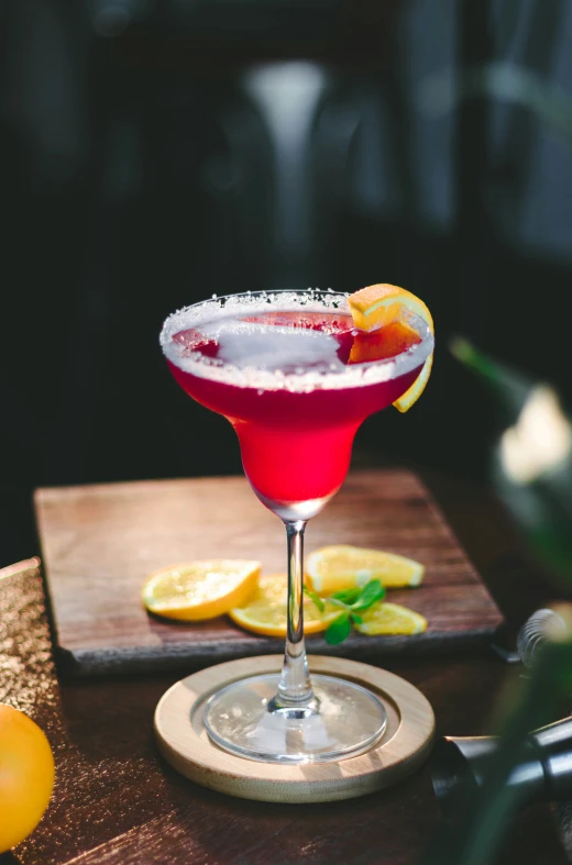 a wine glass with a colorful drink in it