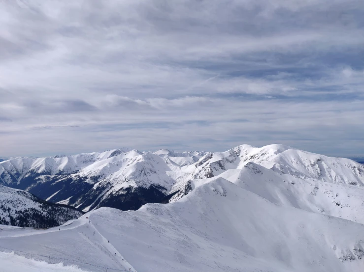 some people snow ski in the mountains covered with snow